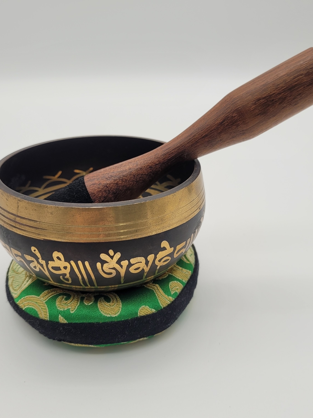 Handcrafted Black and Gold Tibetan Singing Bowl with Green Cushion